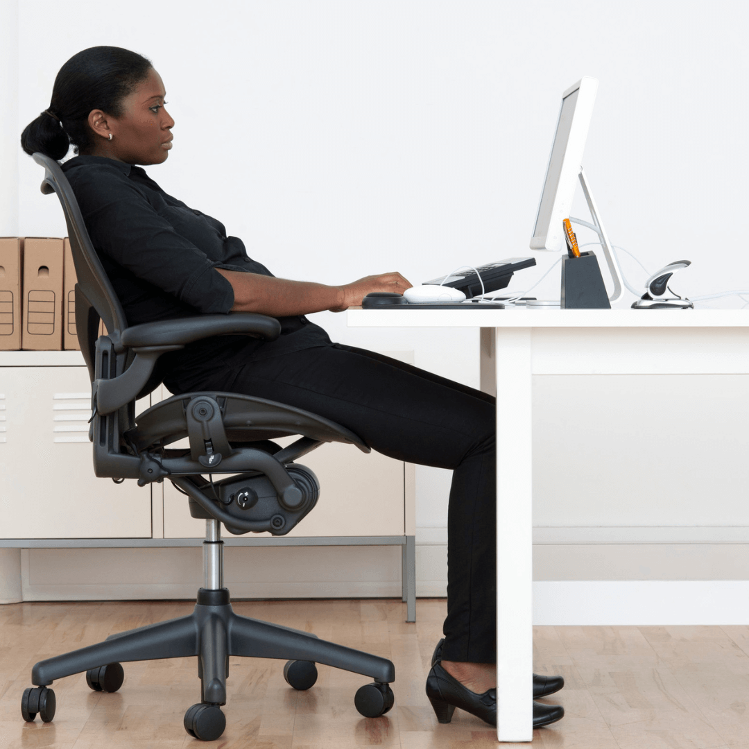 Person slouching at a office desk with a computer screen in front of them