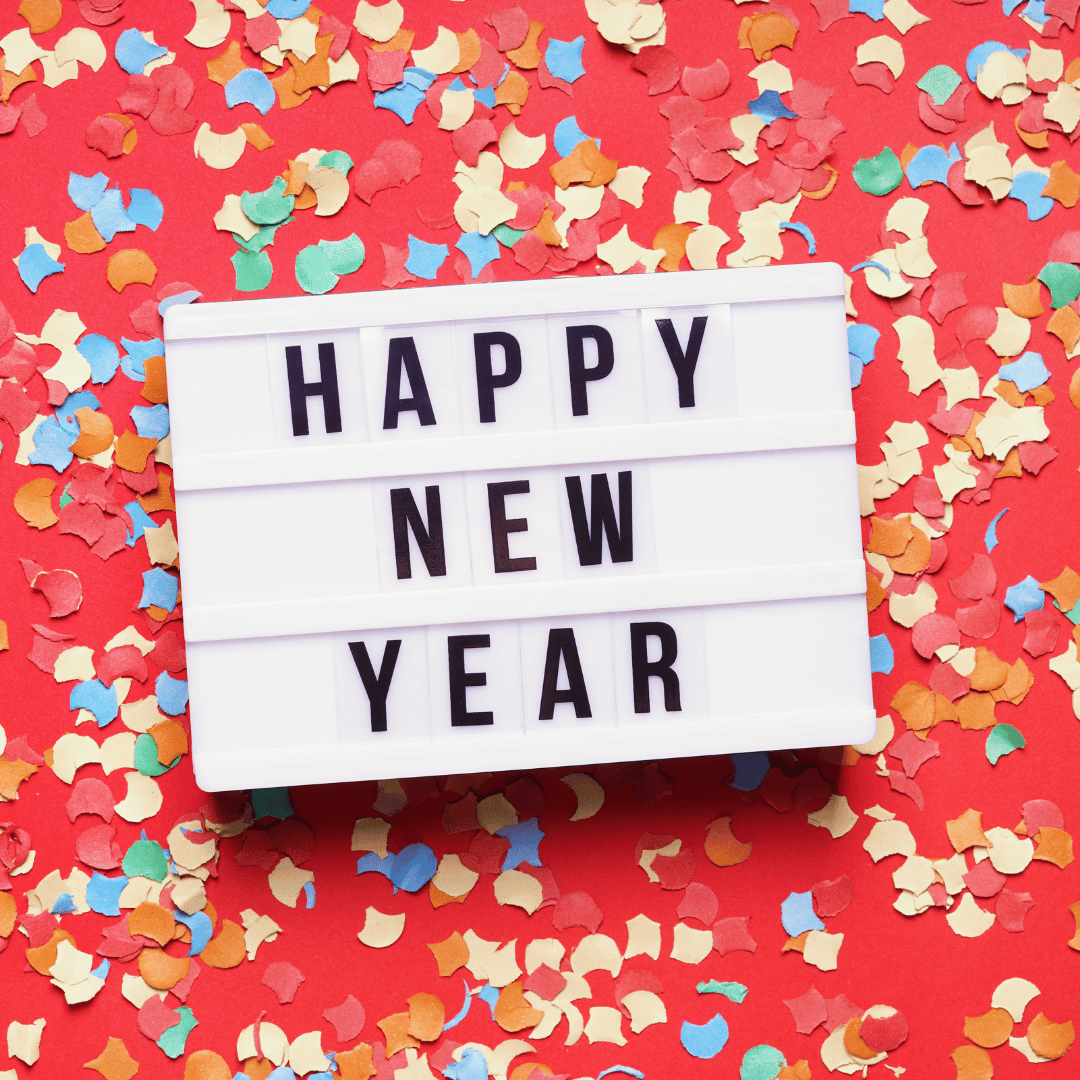 Happy New Year on a marquee with red background and multi colored confetti